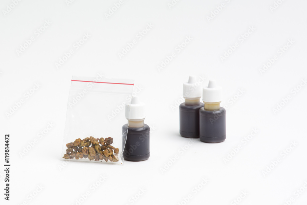 Raw propolis chunks in the ziplock bags and solution of propolis in small plastic bottles. Selective focus. Raw propolis chunks in the ziplock bags and solution of propolis in small plastic bottles. Selective focus.