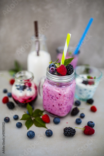 Delicious berry smoothies made with fresh ingredients on light background.
