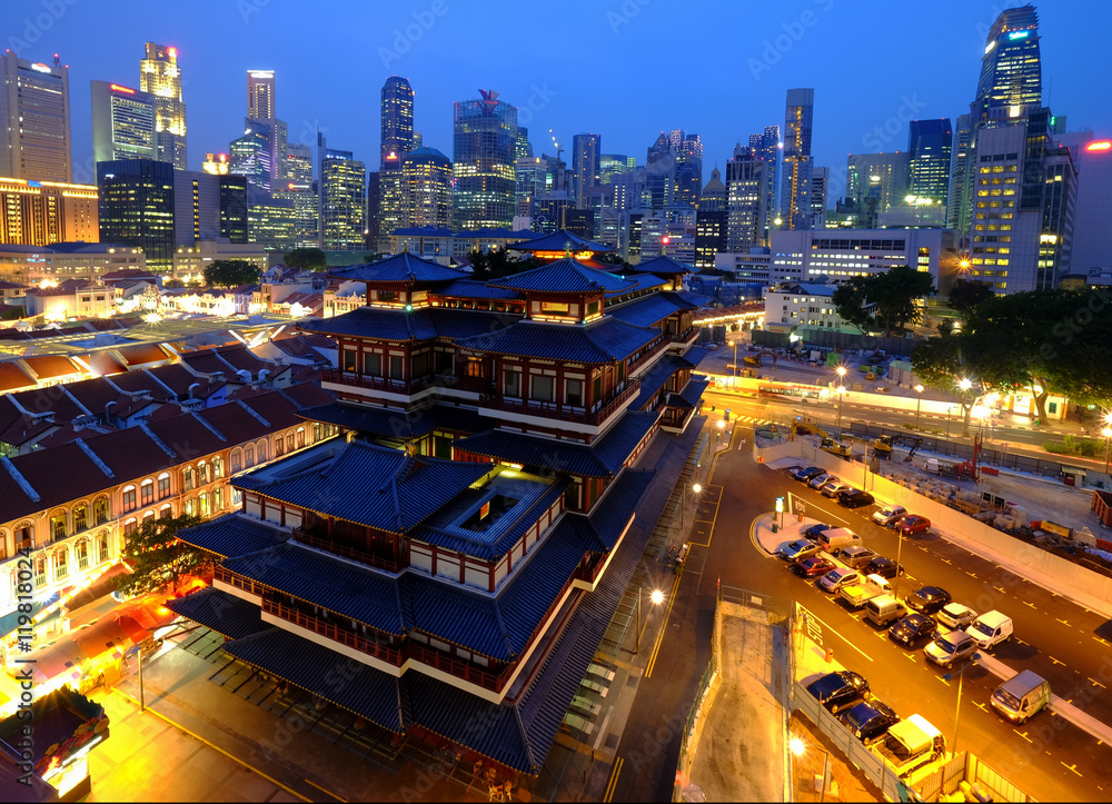 Buddha Toothe Relic Temple in Chinatown in Singapore, with Singapore`s business district in the background.