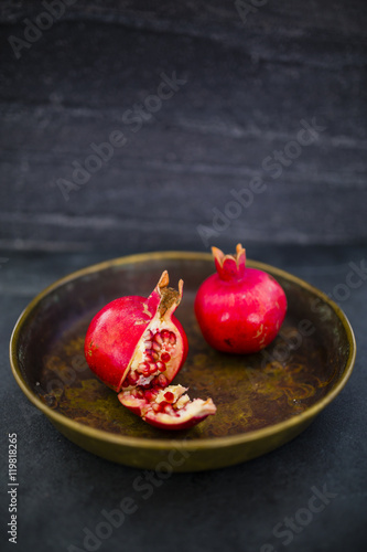 Beautiful still life pomegranate fruit on stone background. Space for text.
