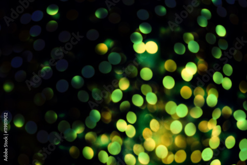 Abstract blurred glitter vintage lights background. Green and b