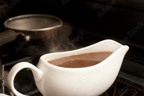 Gravy boat filled with delicious rich gravy photo