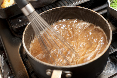 Foto Gravy boiling in a saucepan