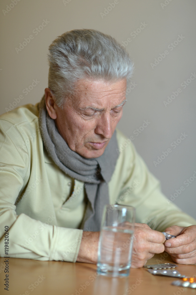 Elderly ill man with pills Elderly ill man with pills