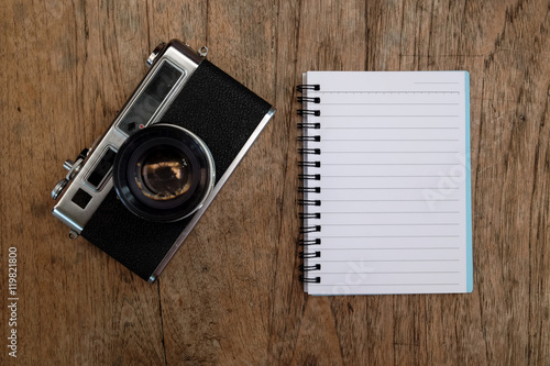 Coffee and camera classic on wooden table.