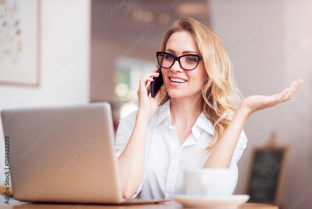 Nice young woman using laptop and phone Nice young woman using laptop and phone