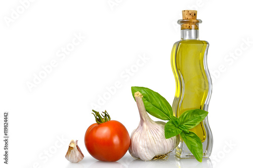 Olive oil and fresh vegetables isolated on white