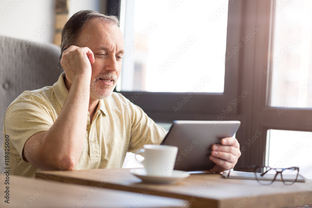 Pleasant senior man talking on cell phone Pleasant senior man talking on cell phone