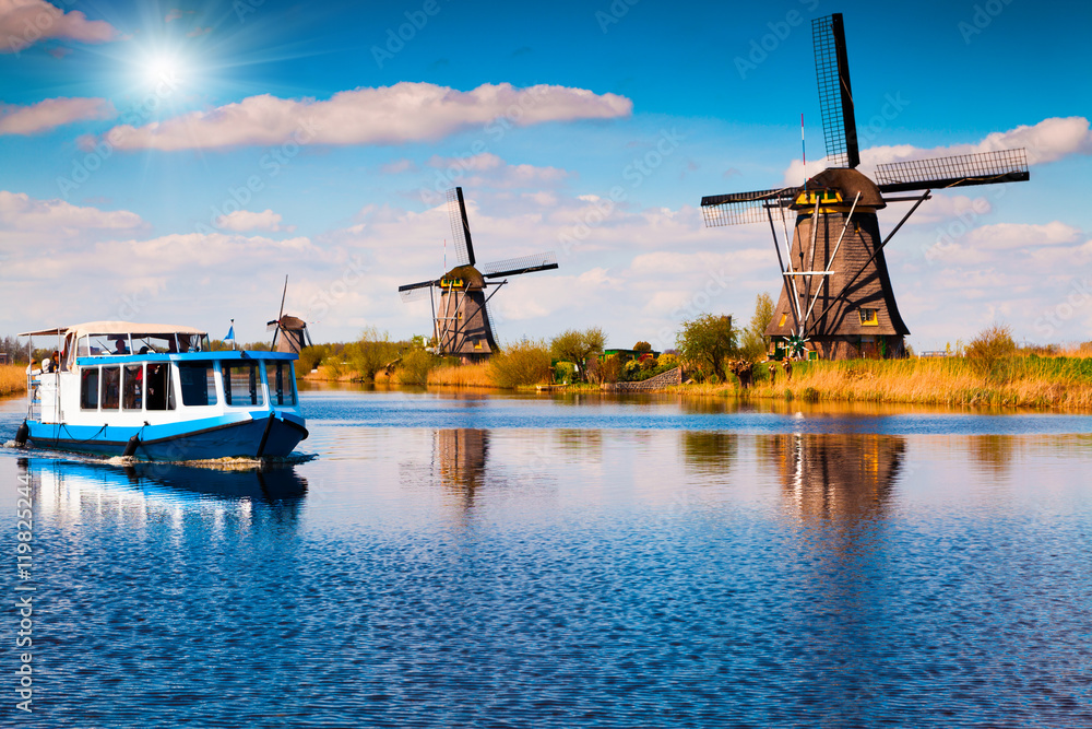 Walking boat on the famous Kinderdijk canal with windmills