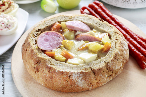 The sour rye soup inside loaf of bread