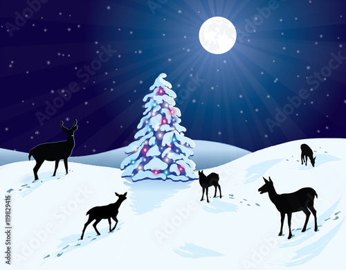 Deer in a snowy winter scene, with a bright moon shining down on a snow-covered Christmas tree that is decorated with colorful lights. © gldcreations