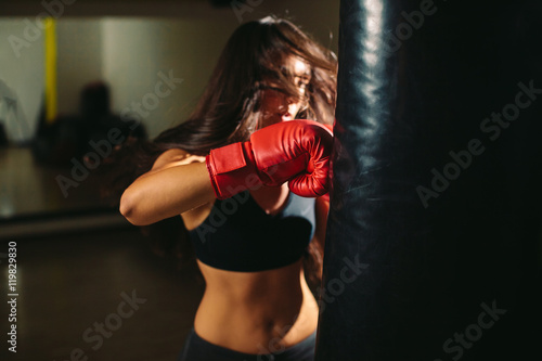 fighter girl punching boxing bag