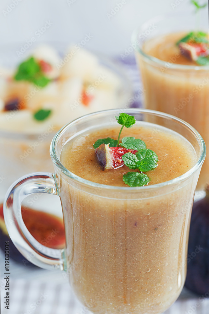 A delicious fresh melon and fig smoothie in a glass with a slice A delicious fresh melon and fig smoothie in a glass with a slice