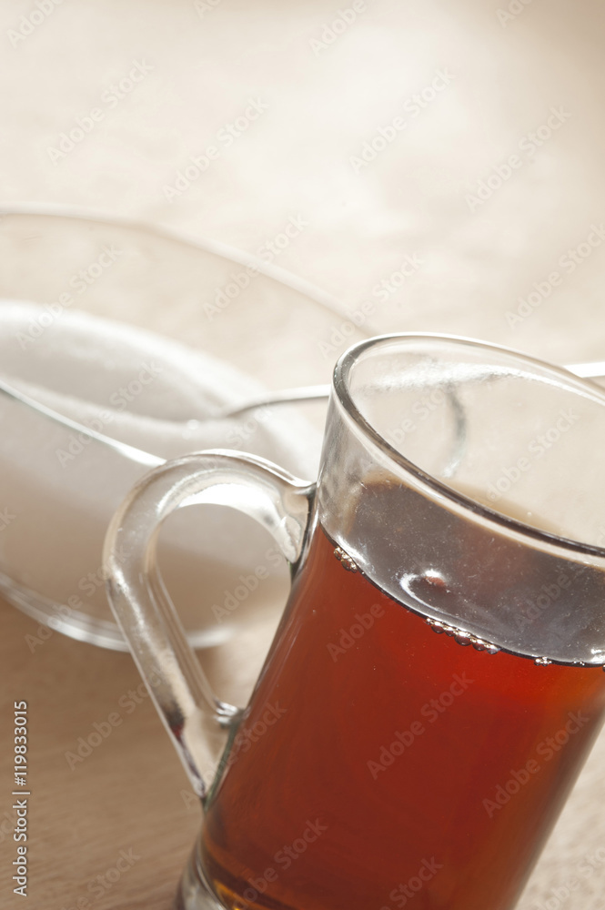 Glass cup of black tea with sugar Glass cup of black tea with sugar