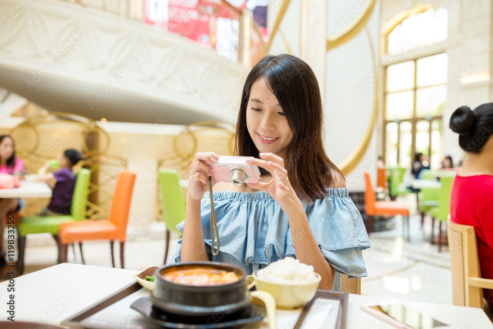 Woman taking photo on digital camera before having the meal Woman taking photo on digital camera before having the meal