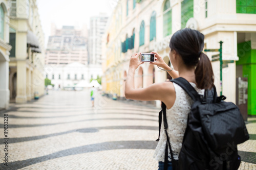 Backpacker taking photo in Macao landmark
