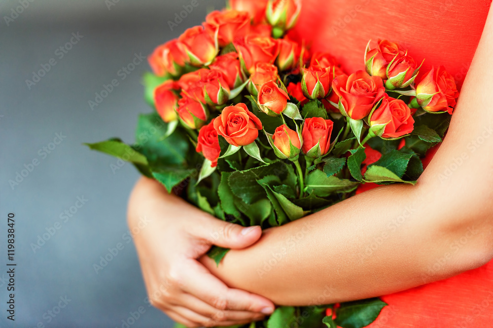 Beautiful bright orange roses in child's hands Beautiful bright orange roses in child's hands