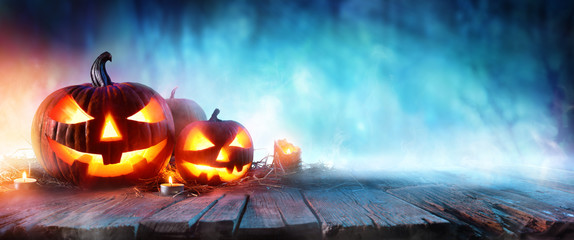 Halloween Pumpkins On Wood In A Spooky Forest At Night
