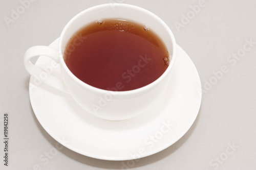 Cup of Hot Black Tea in White Cup with Saucer