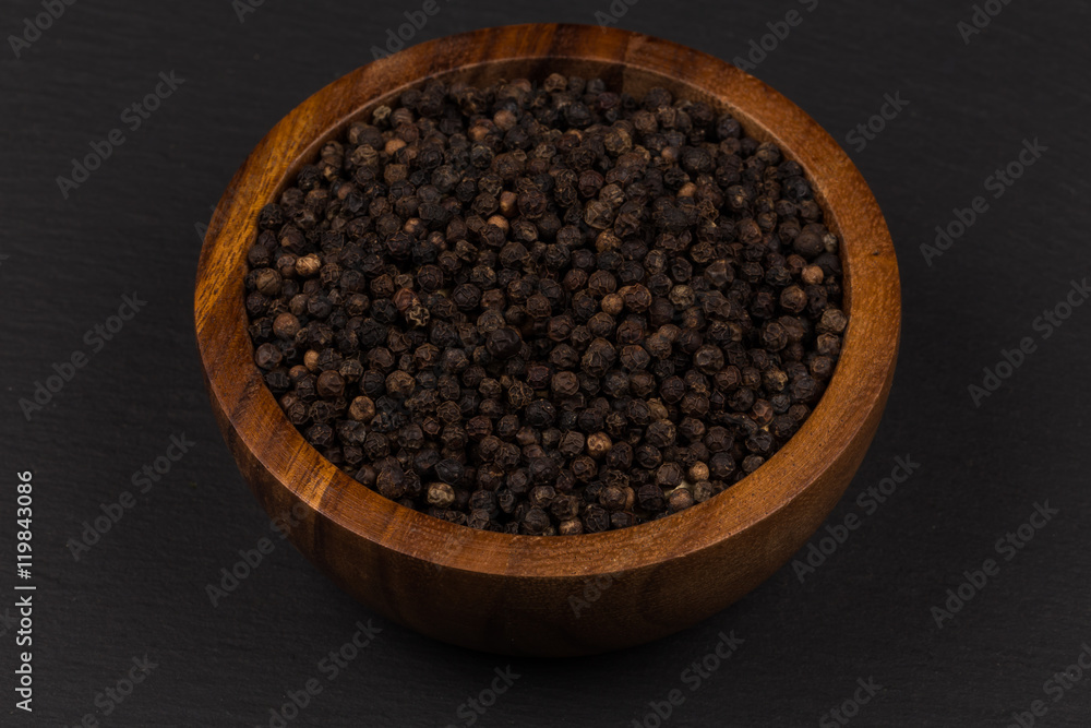 Black pepper in wooden bowl Black pepper in wooden bowl