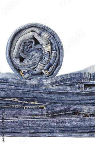 Lot of different blue jeans isolated on white background..