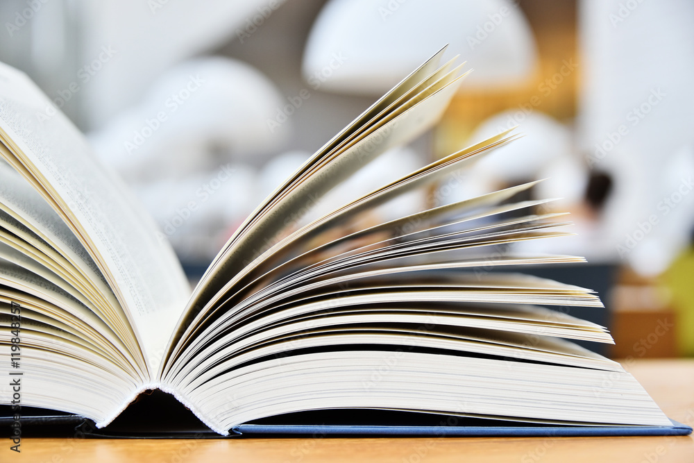 Hardcover book lying on the table in a library