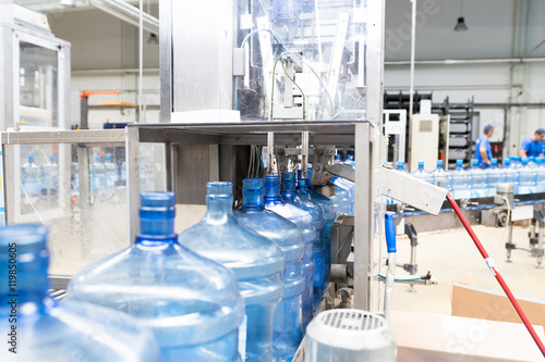 Water factory - Water bottling line for processing and bottling pure spring water into gallons. Selective focus.