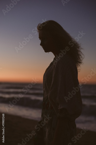 Silhouette of woman on beach sunset sky outdoors background