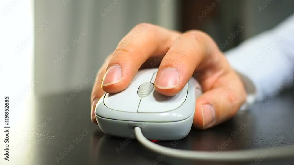 Mouse 18. Soft focus to hand of the man clicking right mouse button. Right hand from front view. Mouse 18. Soft focus to hand of the man clicking right mouse button. Right hand from front view.