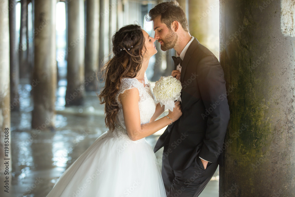 Tuxedo classic wedding dress stylish young newlyweds share a kiss and romantic gaze Tuxedo classic wedding dress stylish young newlyweds share a kiss and romantic gaze