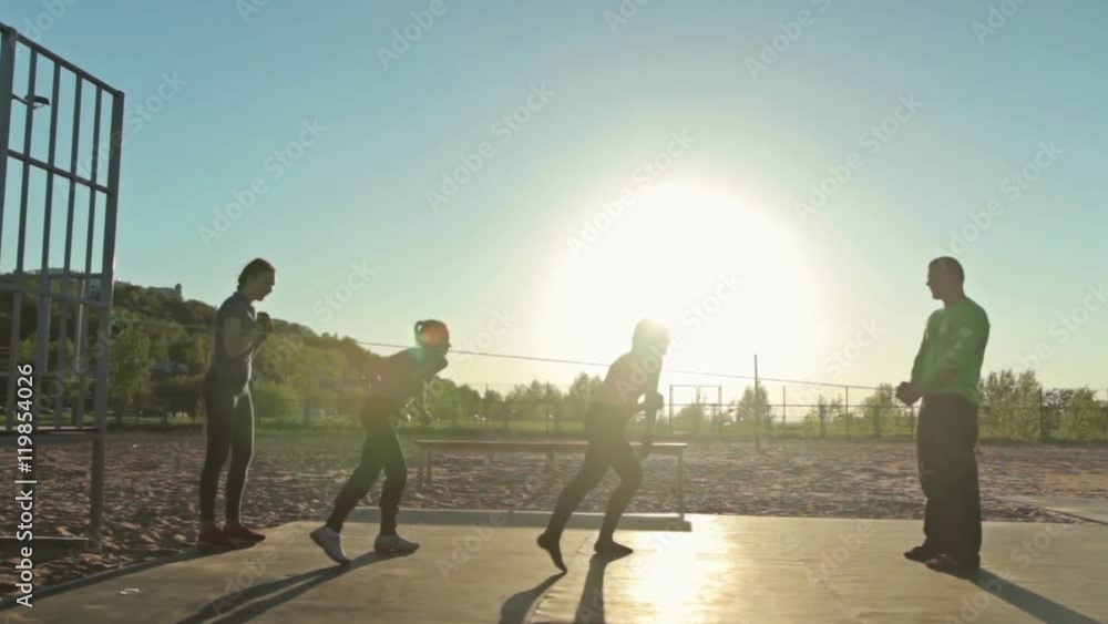 Group of people doing trauning exercise with rope, outdoor crossfit Group of people doing trauning exercise with rope, outdoor crossfit