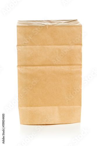 Recycled brown paper bag upside down over white background
