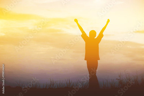 Men, who welcome sunrise with raised hands and enjoying landscap