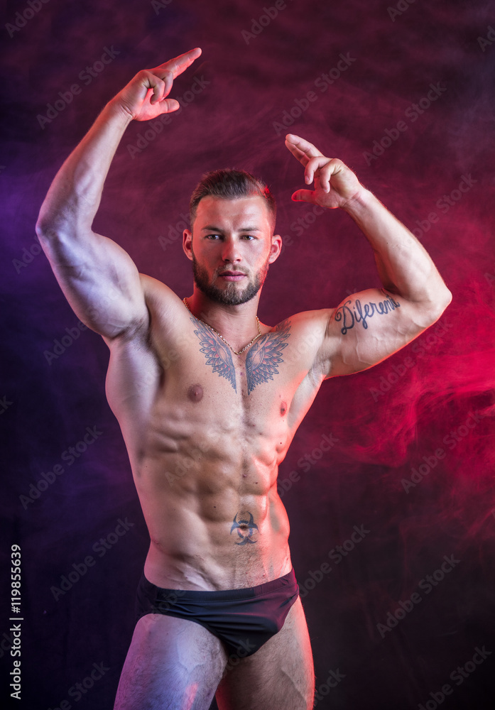 Obraz premium Handsome shirtless muscular man, standing, in studio shot