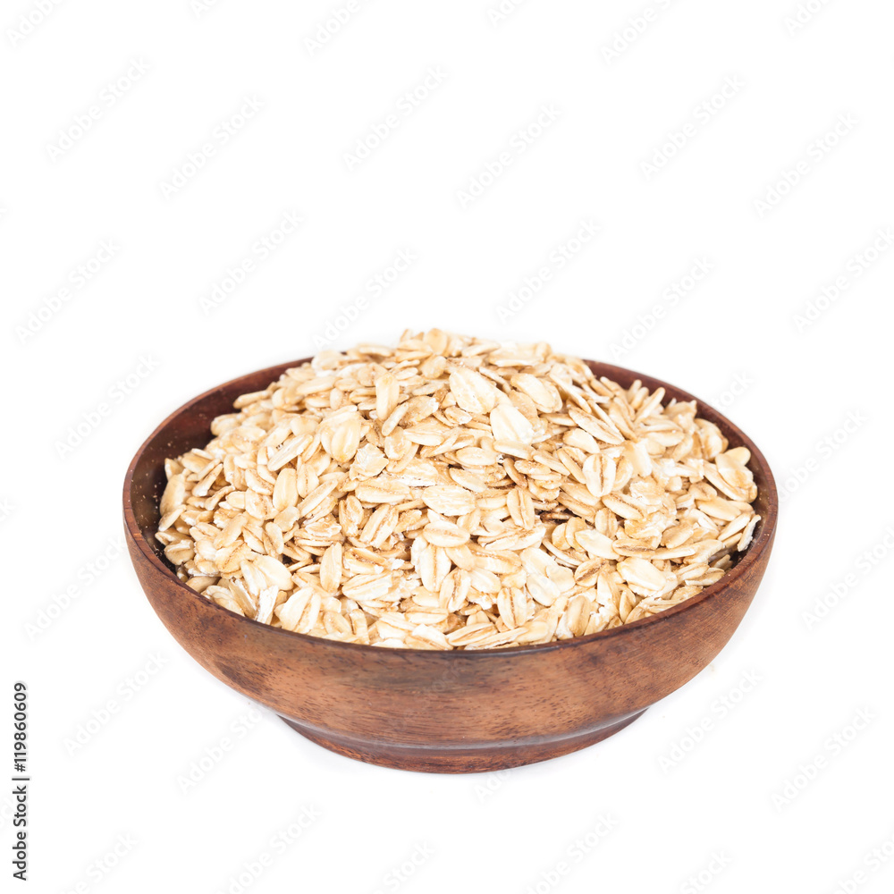 Wooden bowl with oats flakes pile on white background. Wooden bowl with oats flakes pile on white background.