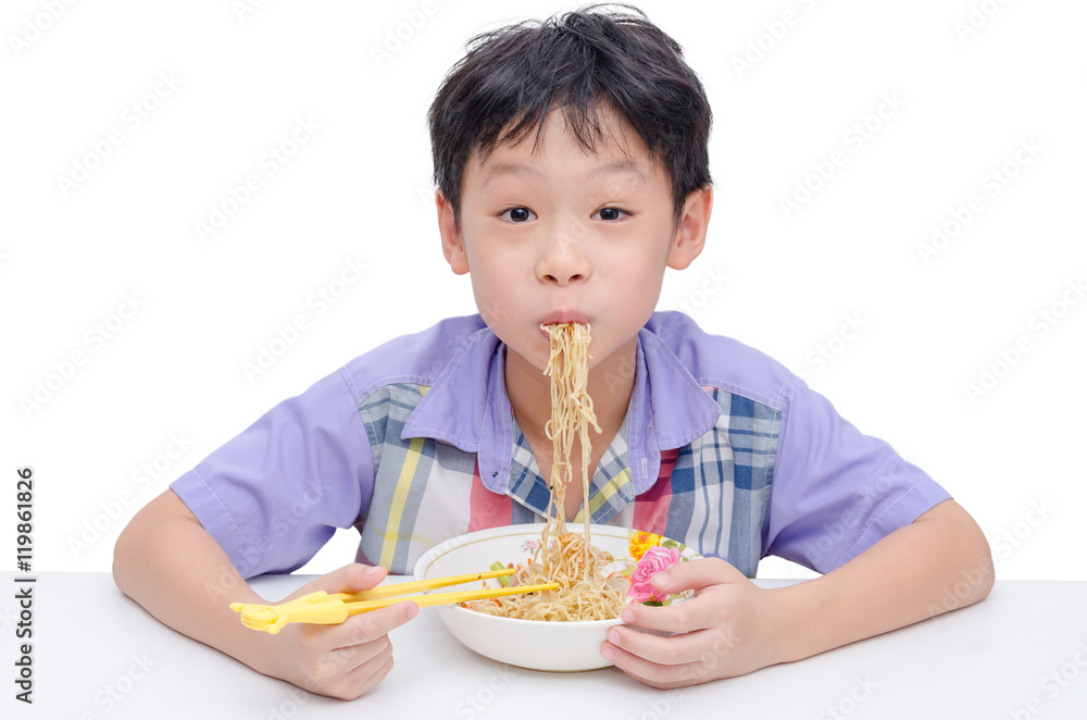 Young asian boy eating noodle by chob stick Young asian boy eating noodle by chob stick