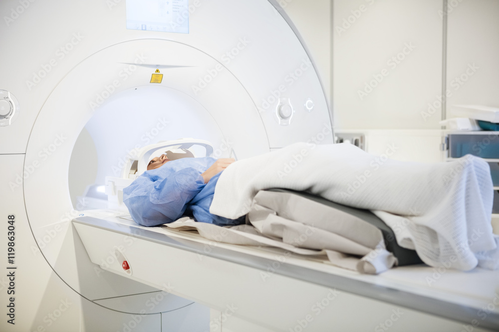 Patient Wearing Head Coil During MRI Scan In Hospital Patient Wearing Head Coil During MRI Scan In Hospital