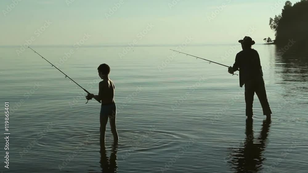 Father and son fishing on the lake. Father and son fishing on the lake.