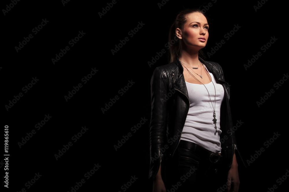 side view of a woman in leather clothes looking up side view of a woman in leather clothes looking up