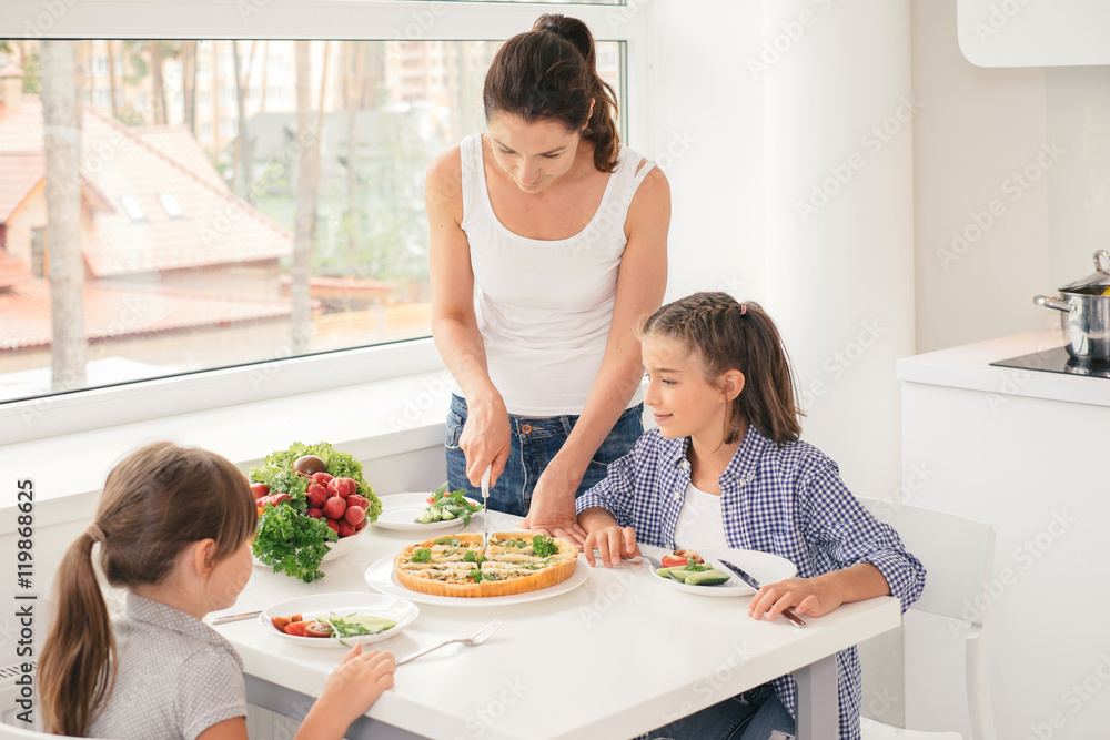 Mother cooking healthy meal for children Mother cooking healthy meal for children