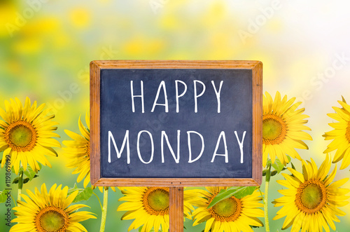 Canvas Print Happy Monday on blackboard with sunflower background