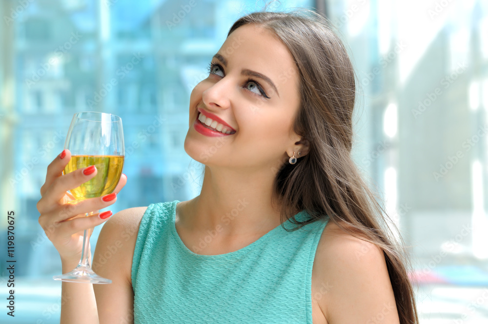 Girl holding in her right hand a full glass of white wine Girl holding in her right hand a full glass of white wine
