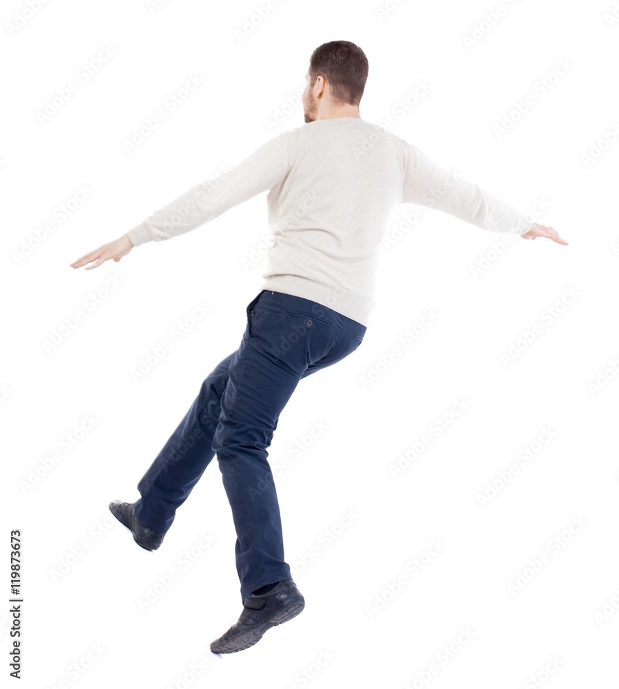 Balancing young man. or dodge the falling man. bearded man in a white warm sweater covers her eyes.... Balancing young man. or dodge the falling man. bearded man in a white warm sweater covers her eyes....