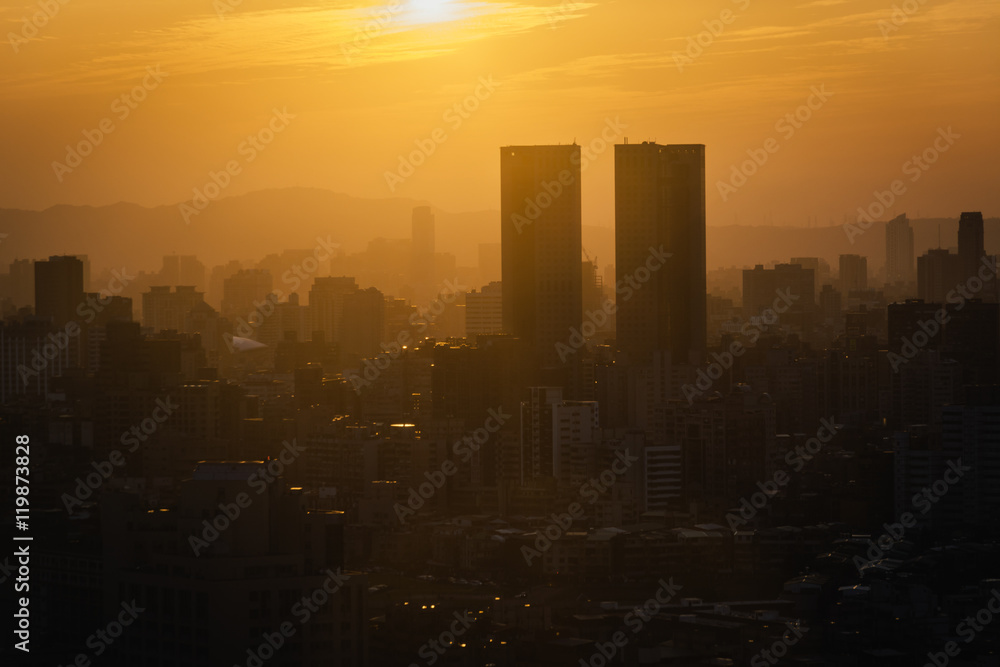 Fototapeta premium View of buildings in haze at sunset, from Elephant Mountain, in