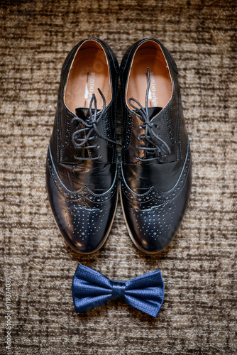 Beautiful stylish man's shoe and tie bow