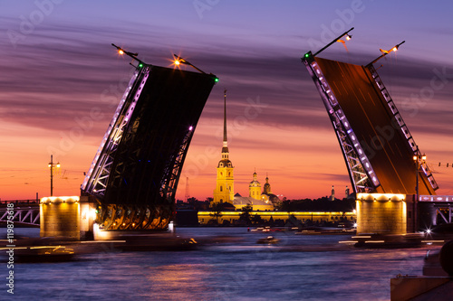 Open Palace Bridge and view of the Peter and Paul Fortress in St.Petersburg in white night photo