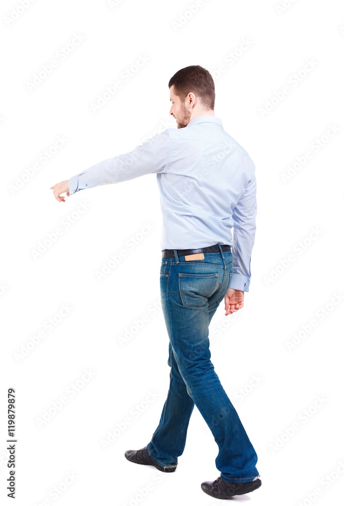 Back view of going business man pointing. Bearded businessman in a white shirt goes diagonally and shows thumb. Back view of going business man pointing. Bearded businessman in a white shirt goes diagonally and shows thumb.