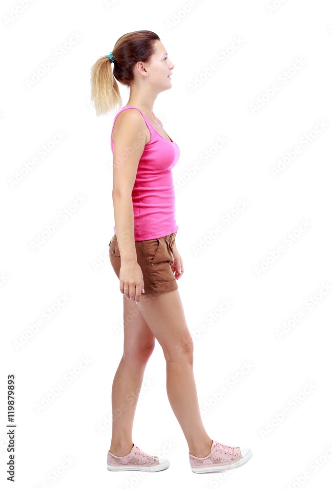 back view of walking woman. beautiful blonde girl in motion. Isolated over white background. Sport blond in brown shorts walks past the camera back view of walking woman. beautiful blonde girl in motion. Isolated over white background. Sport blond in brown shorts walks past the camera