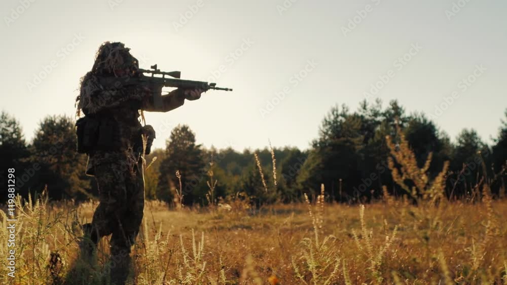 Steadicam shot: Silhouette of armed men, taking aim through the weapon goes ahead Steadicam shot: Silhouette of armed men, taking aim through the weapon goes ahead