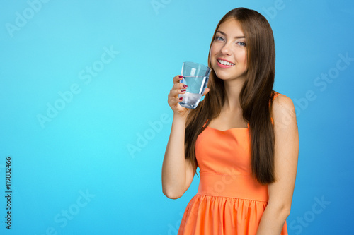 Young woman holding water glass